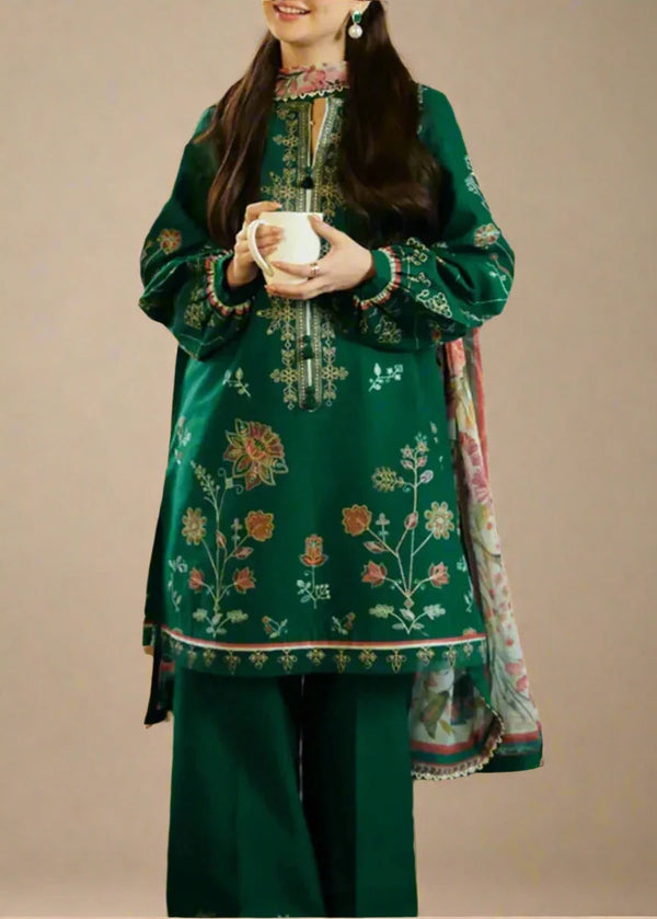 green embroidered traditional outfit with a plain background