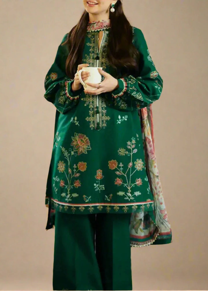 green embroidered traditional outfit with a plain background